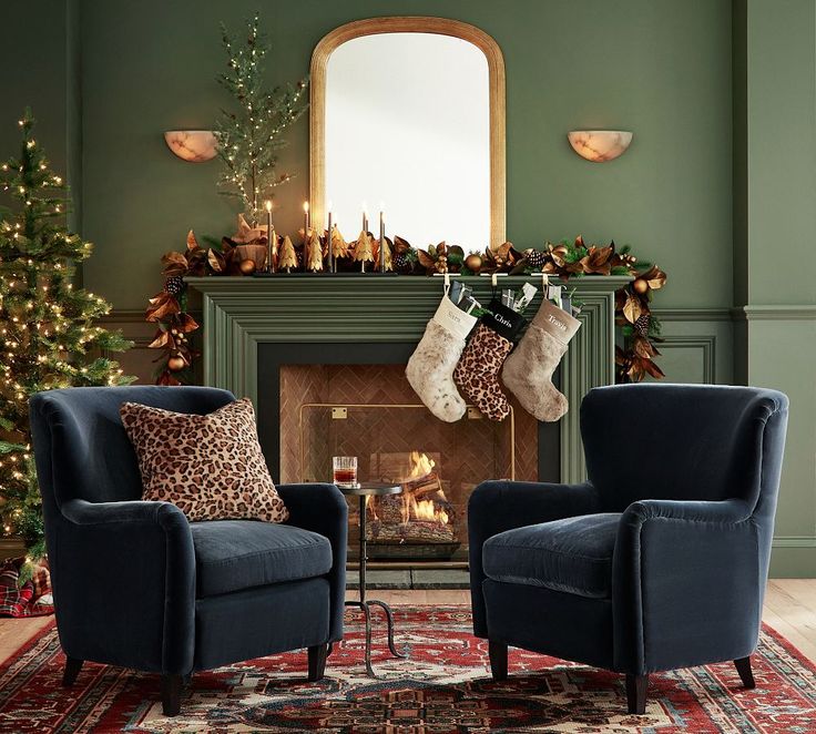 a living room decorated for christmas with stockings on the fireplace