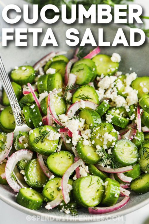 cucumber and feta salad in a silver bowl with a spoon on the side