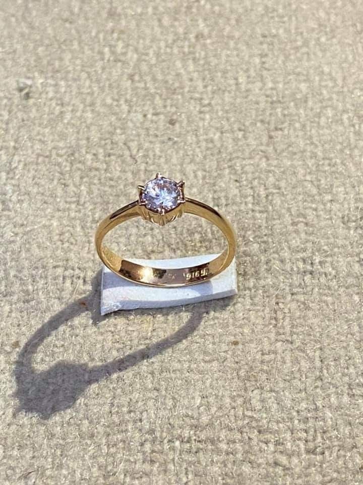 a diamond ring sitting on top of a piece of cloth