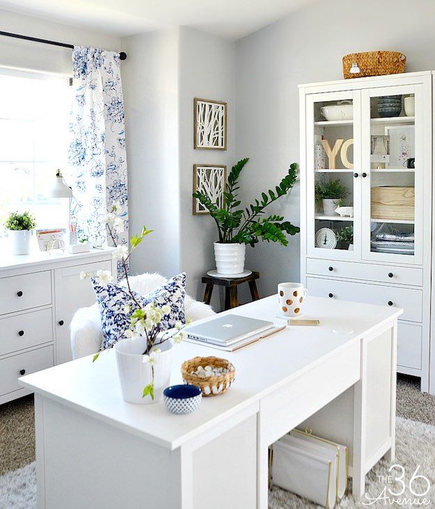 an image of a room with white furniture and decor on the walls, including a ceiling fan