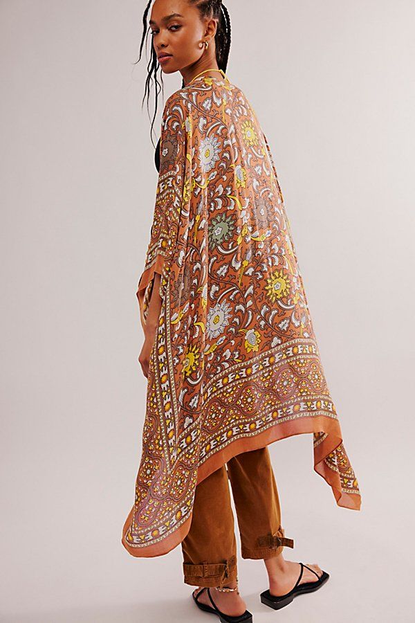 Lightweight kimono featured in a colorful pattern with a border print. Make a statement with this bold style. | Magic Dance Border Print Kimono by Free People in Brown Kimono With Vibrant Print For Festivals, Festival Kimono With Vibrant Print, Spring Patterned Kaftan With Vibrant Print, Patterned Kaftan With Vibrant Print For Spring, Traditional Spring Kimono With Boho Print, Bohemian Patterned Kimono With Vibrant Print, Patterned Kimono With Vibrant Print, Orange Bohemian Kimono With Floral Print, Bohemian Orange Printed Kimono