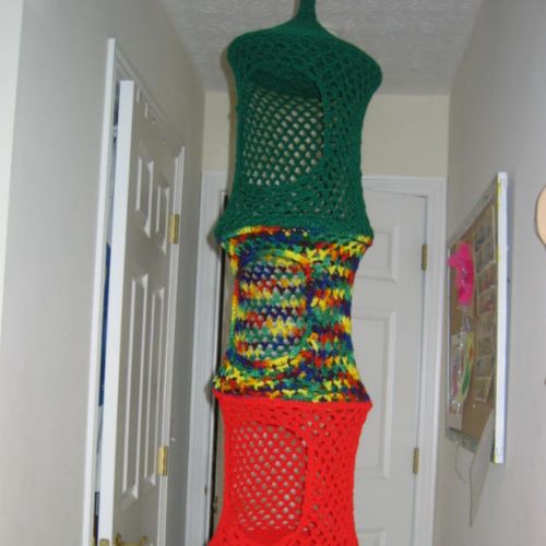 there is a crocheted tower in the hallway