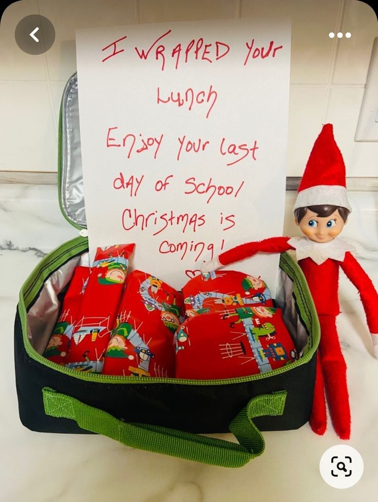 an elf is holding a sign in his suitcase with christmas presents inside it that says, i wrapped your lunch enjoy your last day of school christmas coming