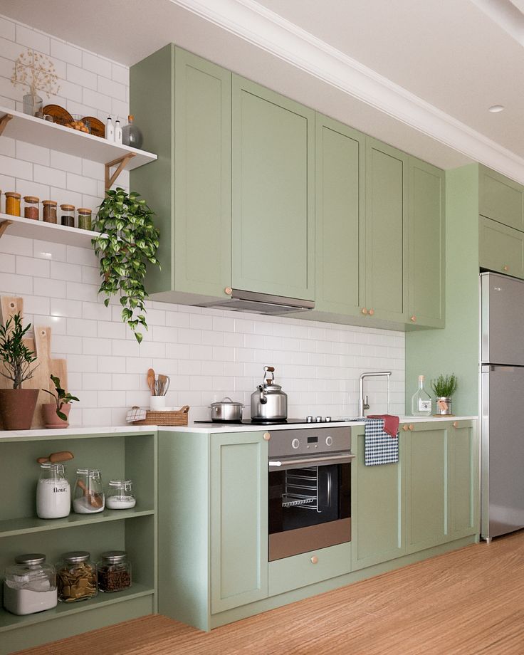 a kitchen with green cabinets and wooden floors