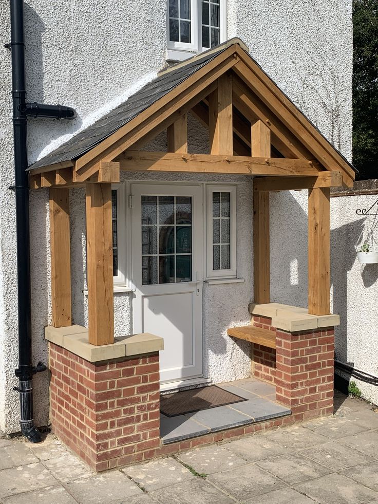 a small white building with a wooden porch