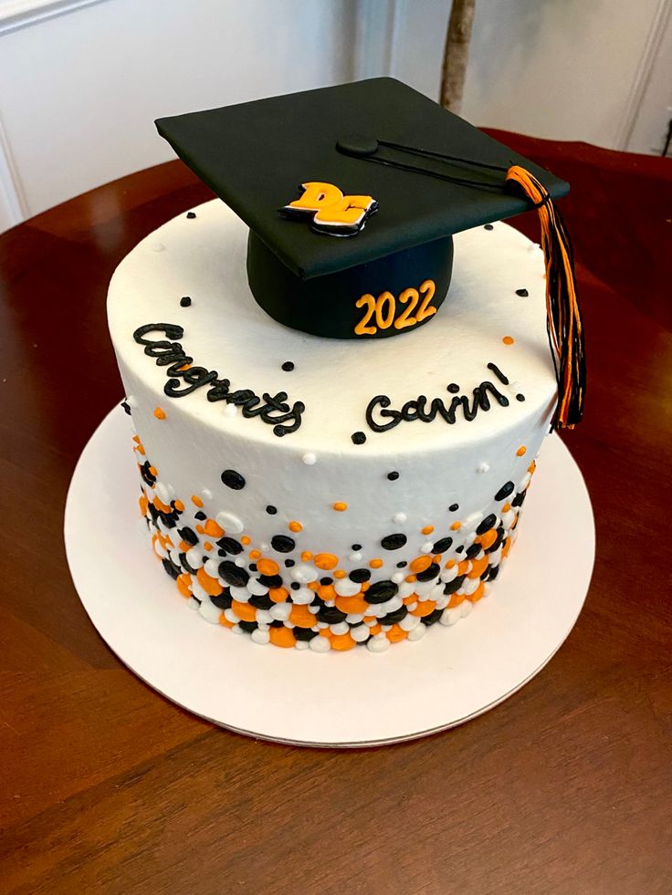 a decorated graduation cake on a wooden table