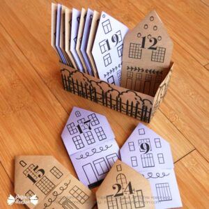 paper houses are arranged on the floor with numbers cut out to make them look like they are