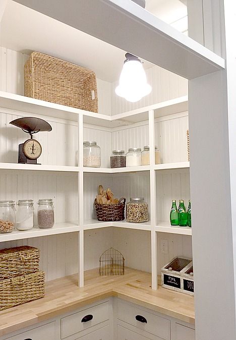 a kitchen with lots of shelves and baskets