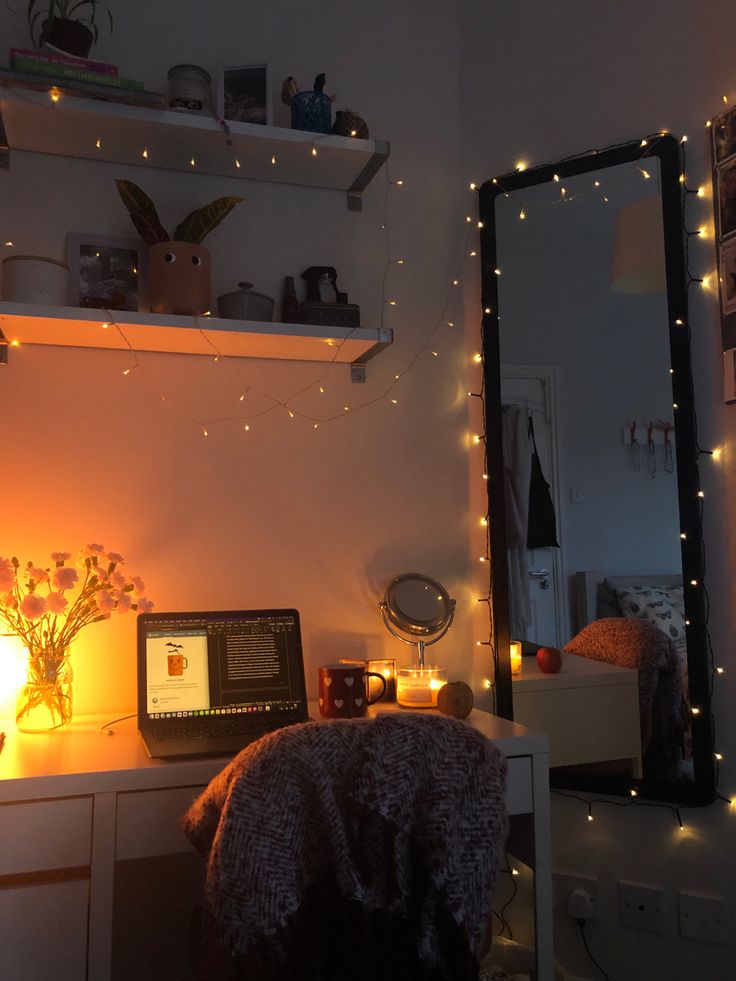 a desk with a computer and some lights on it