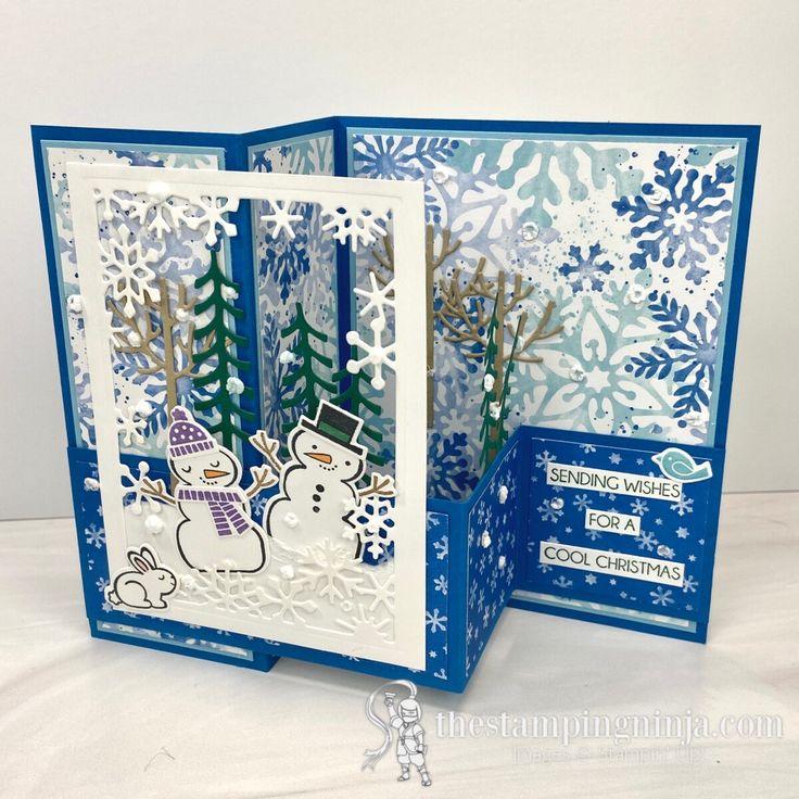 two cards with snowmen and trees on them, one is open to show the inside