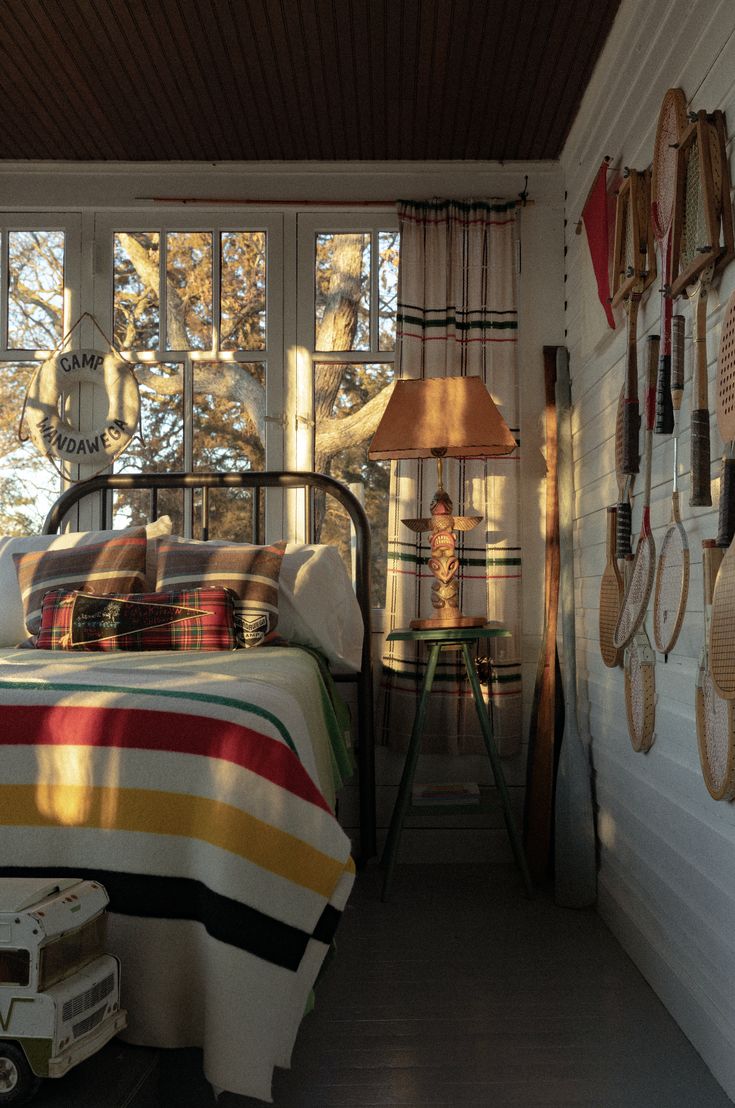 a bed room with a neatly made bed next to a window