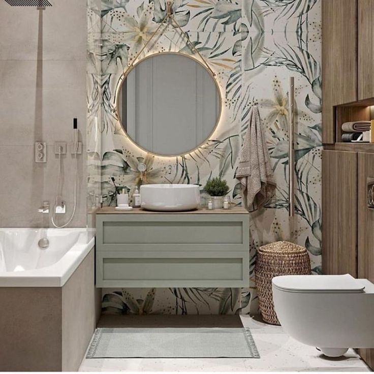 a bathroom with a sink, mirror and bathtub next to a wallpapered wall