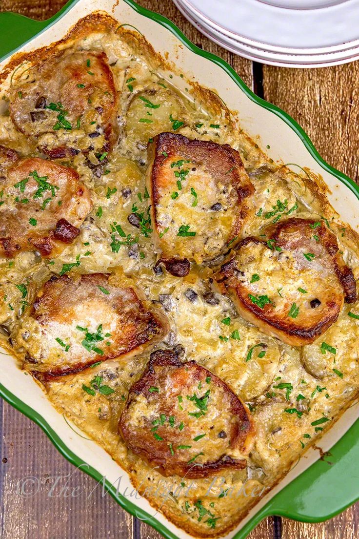 a square casserole dish filled with meat and cheese on a green platter