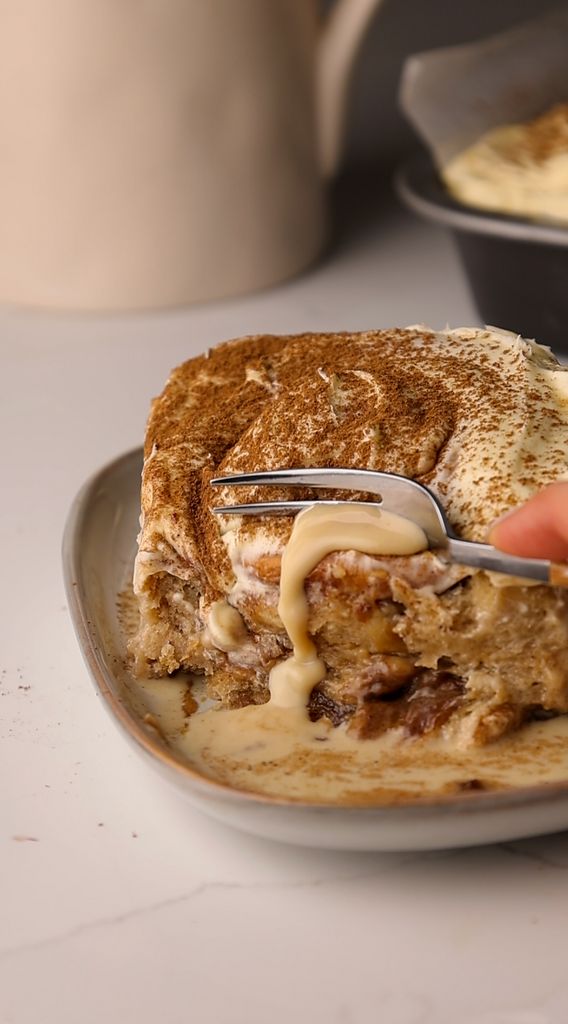 someone is cutting into a sandwich on a plate with a knife and fork in it