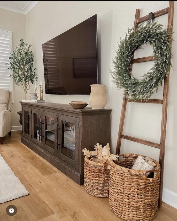 a flat screen tv sitting on top of a wooden entertainment center