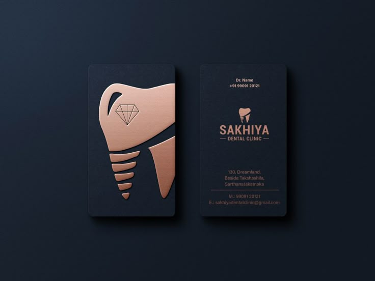 two business cards designed to look like toothbrushes with diamonds on the front and back