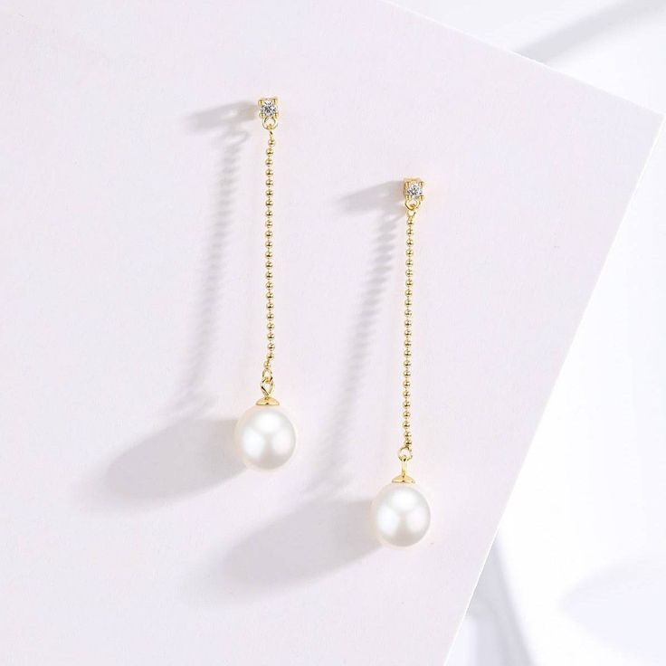 Elevate your ensemble with the exquisite elegance of our Natural Freshwater Pearl Long Earrings. Crafted with AAAA-grade natural freshwater pearls, these earrings boast a luxurious allure. Set in s925 silver with stunning 18K gold vermeil details, they exude sophistication and charm. Perfect for special occasions, these earrings offer a timeless and opulent look that enhances any outfit. The top stud features a sparkling cubic zirconia, while a long bead drop chain culminates in a lustrous 8-9mm Pearl Long Earrings, Long Pearl Earrings, Freshwater Pearl Earrings, Pearl Necklace Earrings, Baroque Pearl Earrings, Gold Pearl Necklace, Best Gifts For Her, Freshwater Pearls Earrings, Pearl Collection