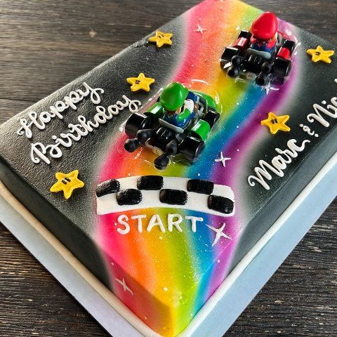 a birthday cake decorated with cars and stars