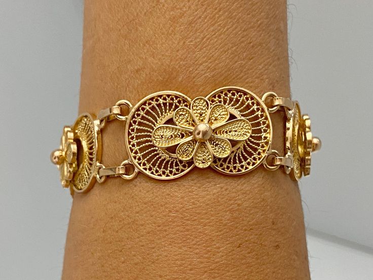 "Pacific Jewelry Key West Presents, Vintage Filigree bracelet, circa 1960's. Beautiful and intrinsic lace design, super feminine and just beautiful to look at. This bracelet is a true testament to fine craftsmanship with pliable threats and curls in 14K Yellow gold. ✔ Antique filigree bracelet ✔ Gold Karat: 14K ✔ Authentic art deco metalwork ✔ Chain attached at closure for added safety. ✔ Circa 1960's ✔ Hypoallergenic ✔ Intrinsic lace design ✔ 7.0 inches long ✔ Closure: Hinged Clip **Please mess Ornate Yellow Gold Bracelets For Ceremonial Occasions, Ornate Yellow Gold Bracelet, Ornate Yellow Gold Jubilee Bracelet, Formal Yellow Gold Bracelet With Intricate Design, Ornate Hallmarked Yellow Gold Bracelet, Antique Yellow Gold Bracelets With Intricate Design, Victorian Style Yellow Gold Bracelets With Intricate Design, Ornate Yellow Gold Bracelets With Intricate Design, Adjustable 14k Gold Jewelry With Intricate Design