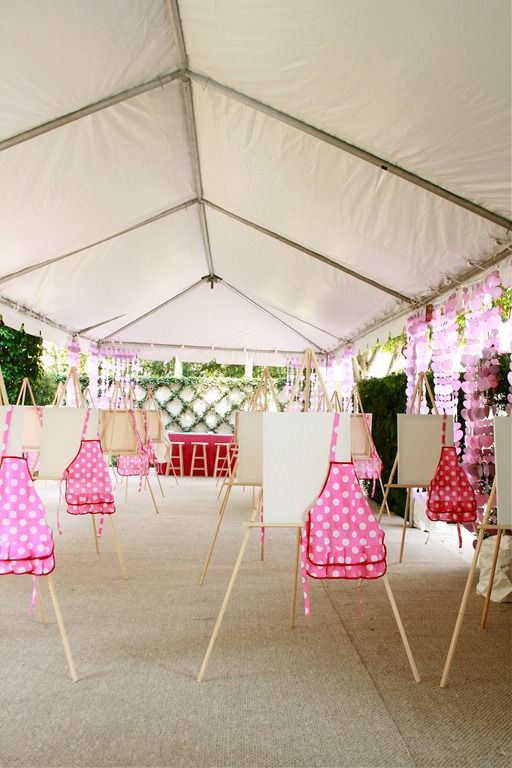 the inside of a tent with pink and white polka dots on it, hanging from strings