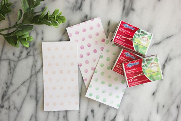 four boxes of soap sitting on top of a marble counter next to a plant and some tissues