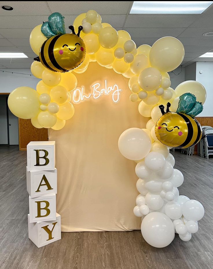 a baby shower with balloons and bums on it's head is displayed in an office