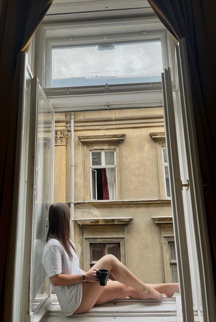 Morning coffee girl sitting on windowsill aesthetic in Italy Sitting In Window Aesthetic, Window Pictures Poses, Sitting On Window Sill Aesthetic, Leaning Out Car Window Pose, Window Photoshoot Ideas, Sitting On Window Sill, Woman Sitting On Windowsill, Pretty Settings, The Woman In The Window Aesthetic