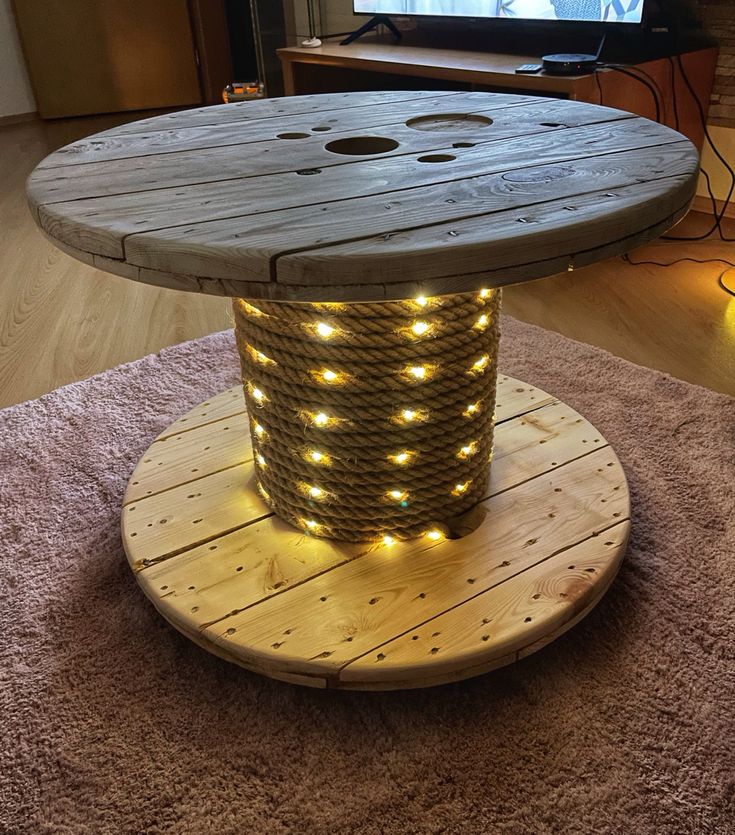 a round table with lights on it in the middle of a living room and tv