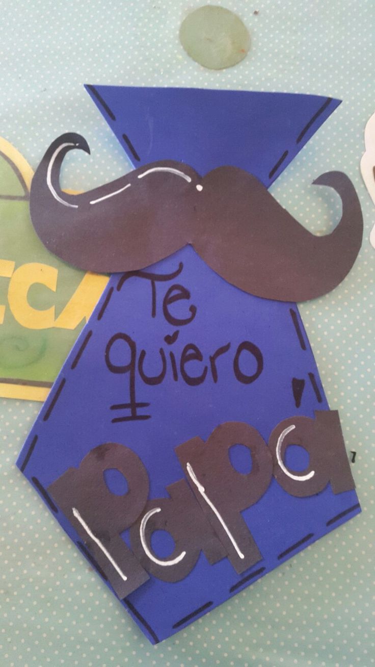 a paper cut out of the shape of a mustache on top of a blue table cloth