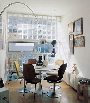 a living room filled with furniture next to a window