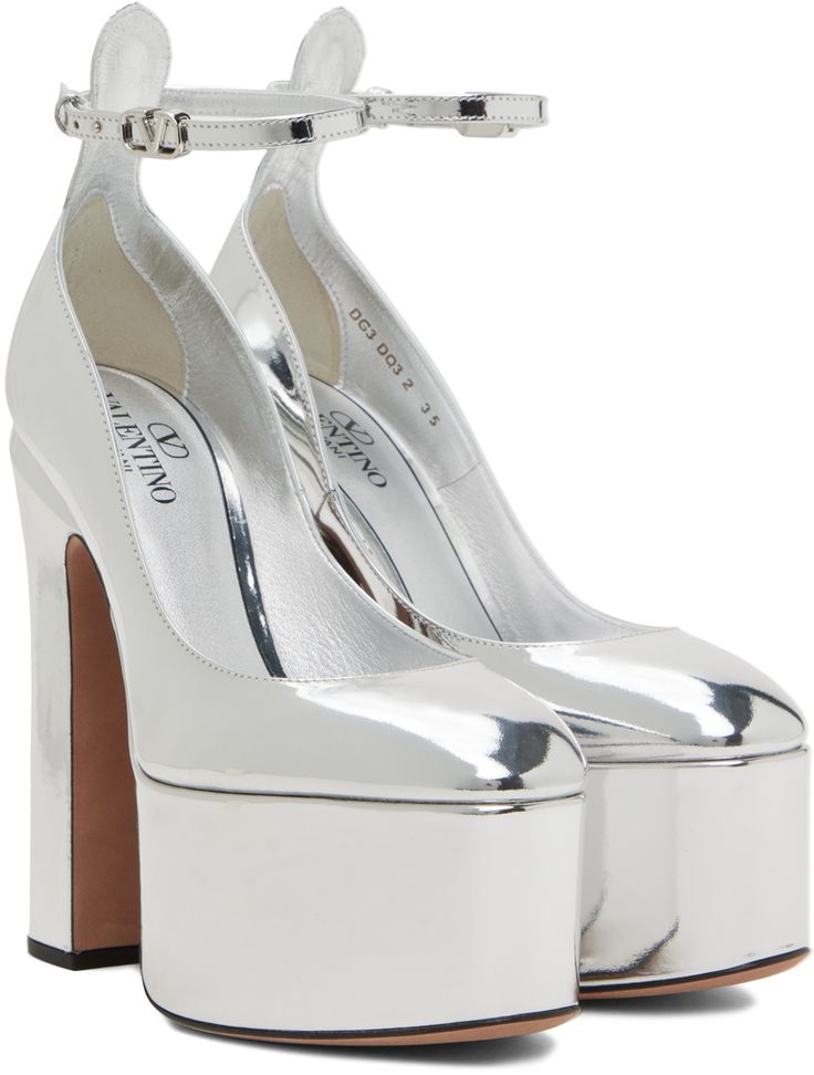 Patent leather heels in silver-tone. · Logo hardware at pin-buckle strap · Logo stamp at grained leather footbed · Covered block heel with rubber injection · Suede sole in beige · Platform: H2 in · Heel: H5 in Supplier color: Silver Luxury Silver Heels With Buckle Closure, Metallic Leather Heels With Buckle Closure, Modern Silver Heels With Buckle Closure, Formal Silver Heels With Buckle Closure, Silver Patent Leather Heels With Heel Strap, Silver Leather Heels With Sculpted Heel, Silver Heels With Heel Strap In Patent Leather, Modern Metallic Silver Leather Heels, Formal Silver Platform Heels