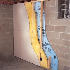 an unfinished room with exposed walls and insulation in the wall, showing how to cut through it