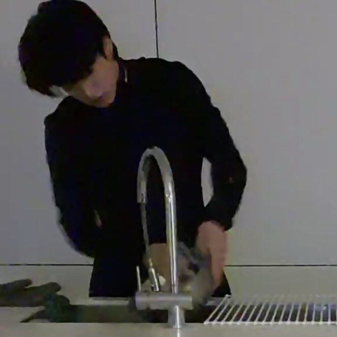 a man is washing his hands in the sink