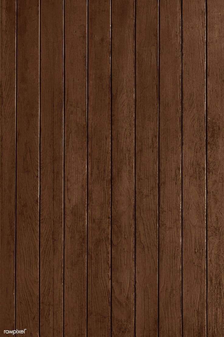 a brown wood paneled wall with vertical planks in the center and bottom part