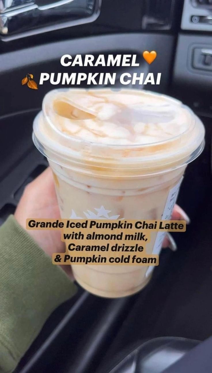 someone holding up a cup of pumpkin chai in their hand with the caption caramel pumpkin chai