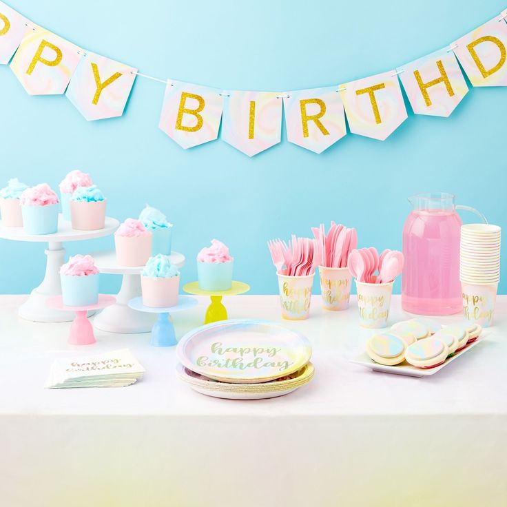 a table topped with lots of cake and cupcakes