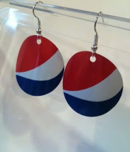 two red, white and blue earrings hanging from a hook