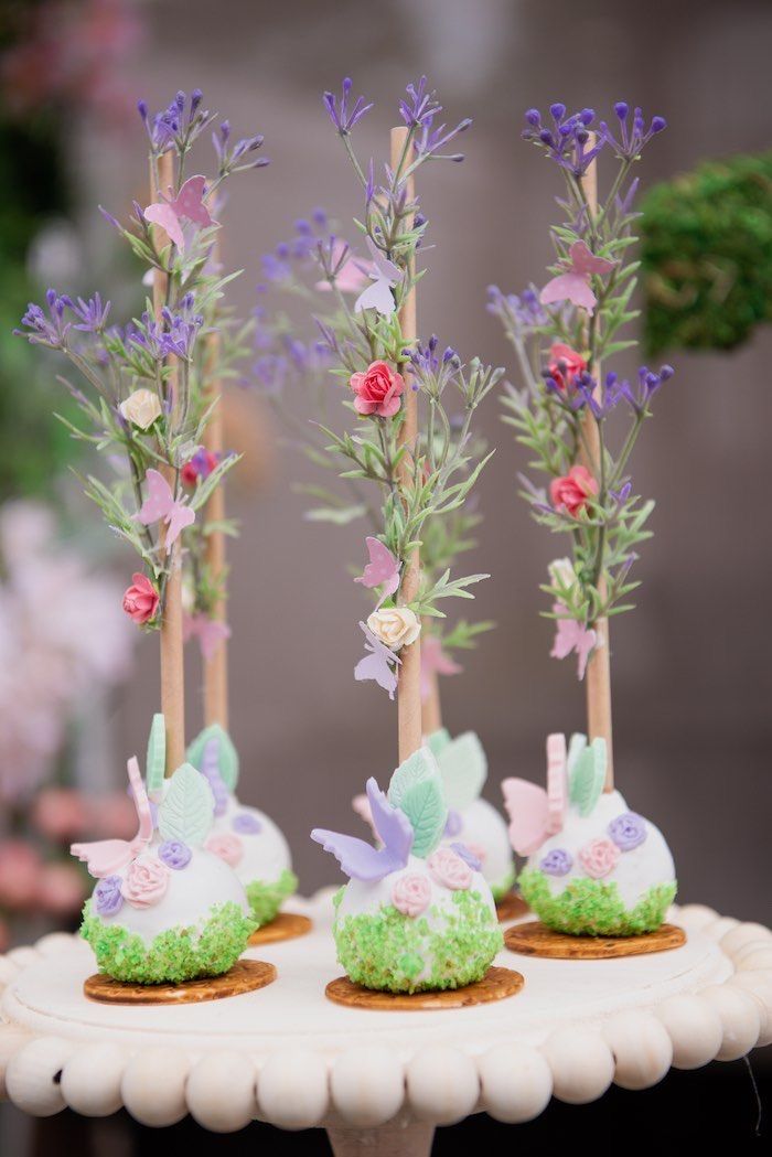 small cupcakes decorated with flowers and grass