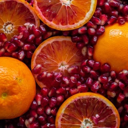 oranges and pomegranates cut in half