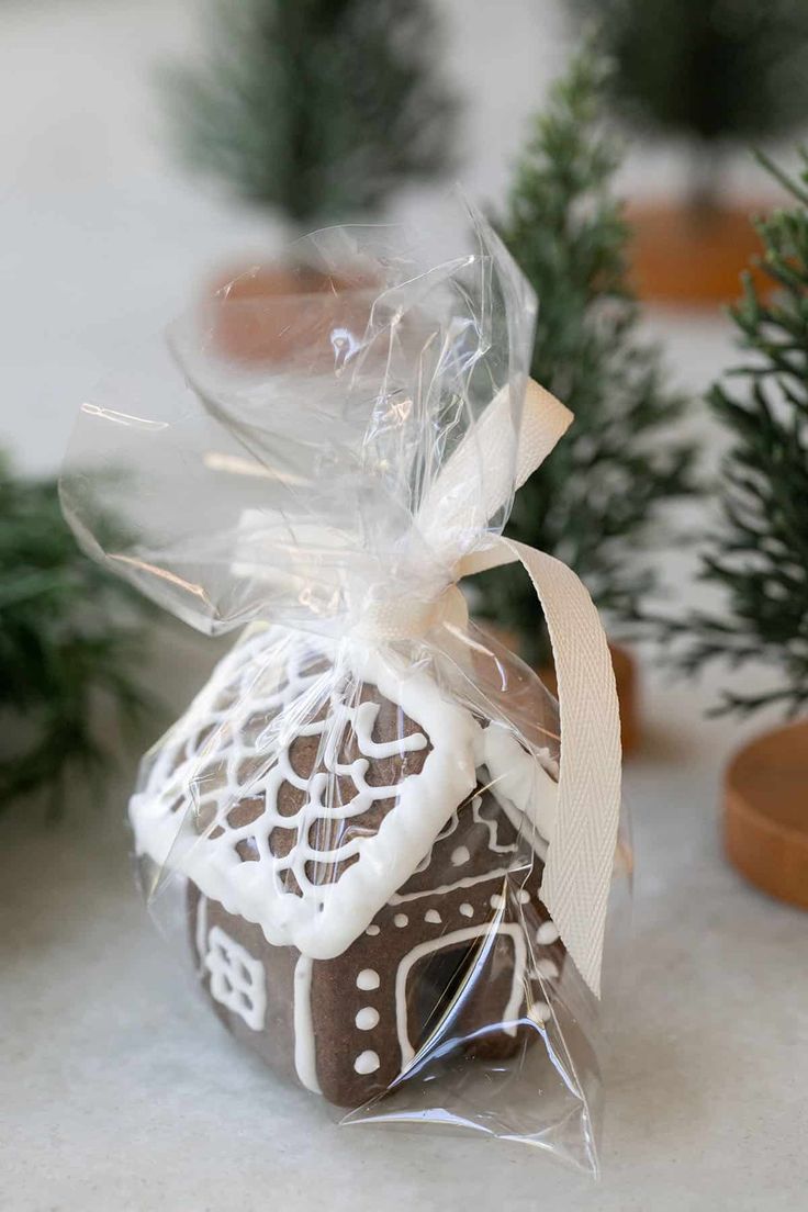 a small gingerbread house is wrapped in plastic