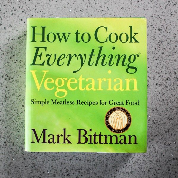 the book how to cook everything vegetarian by mark bitman is sitting on a table