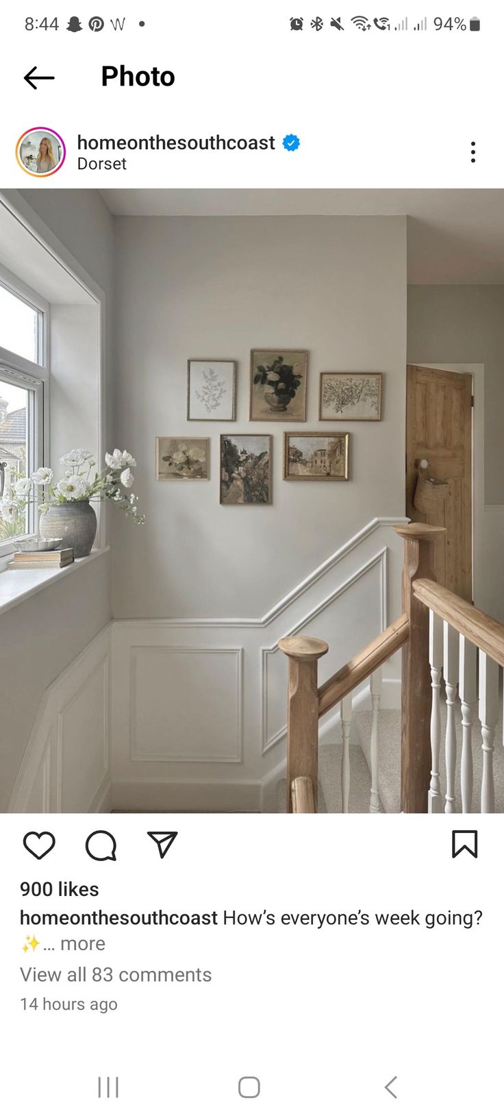 an instagramted photo of someone's house with pictures on the wall and stairs