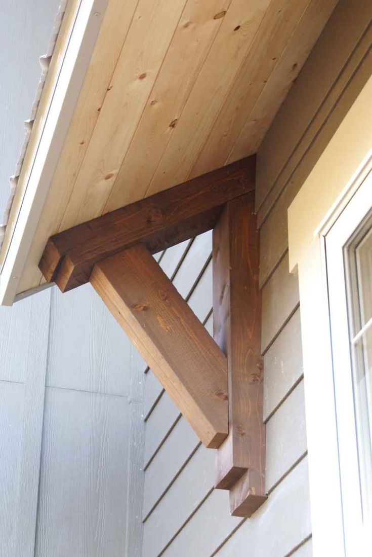 the corner of a house with wood on it