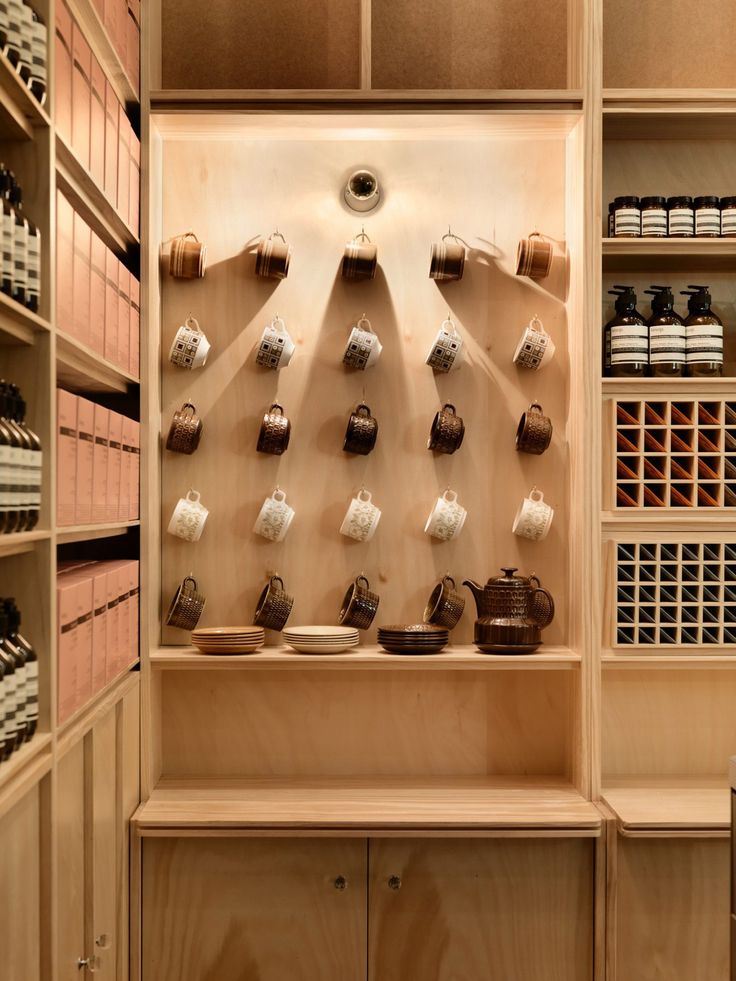 the shelves are filled with many different types of cups and teapots on them