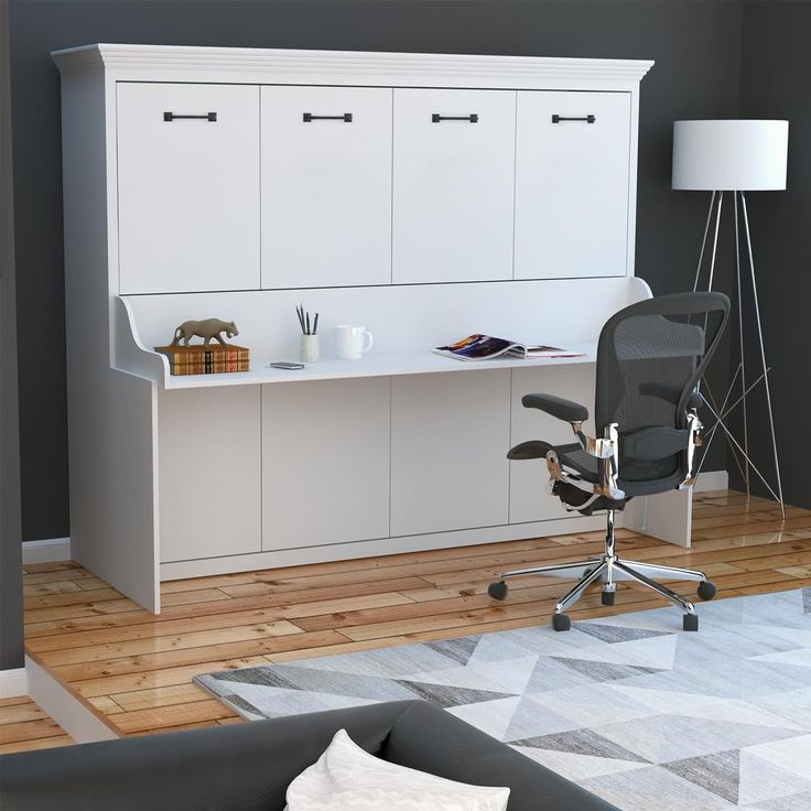 an office with a desk, chair and cabinets in the corner by the couches