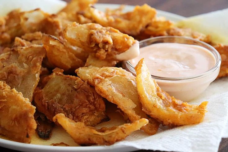 fried food on a plate with dipping sauce