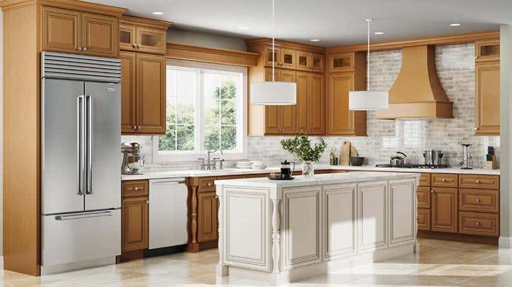 a large kitchen with wooden cabinets and stainless steel appliances, including an island in the middle