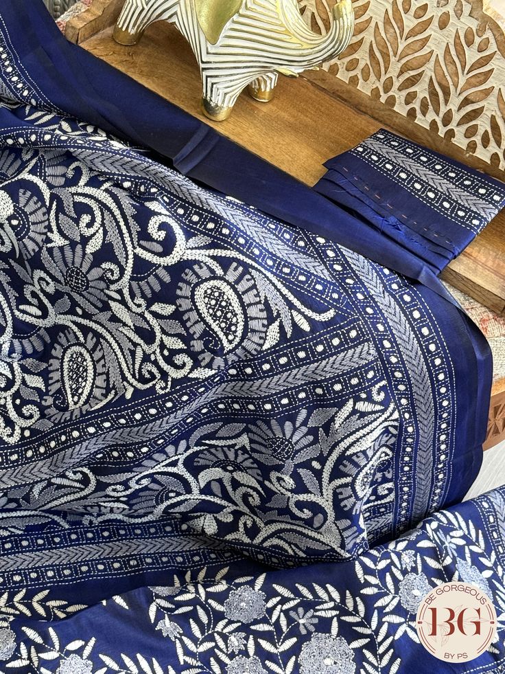 Indulge in luxury and elegance with our Kantha Stitch Saree on bangalore silk - blue. Crafted with intricate and delicate Kantha stitching, this saree is a true masterpiece. Pure bangalore silk creates a lustrous and smooth drape, while the beautiful blue color adds a touch of sophistication. Elevate your style with this exclusive saree. Kantha Stitch on bangalore silk - blue Saree comes with a blouse piece. Fall and pico done. Fully stitched blouse shown in pictures is optional and can be purchased seperately from our blouses and croptops section. For saree video please connect with us on whatsapp @469-937-0606 Ready to be shipped in USA from San Diego, California. All pictures are original pictures. Colors may slightly vary due to pic resolution. Indigo Traditional Wear With Chikankari Embroidery For Diwali, Indigo Traditional Wear With Resham Embroidery For Wedding, Indigo Traditional Wear For Wedding With Cutdana Details, Indigo Wedding Traditional Wear With Cutdana, Traditional Indigo Sets With Resham Embroidery, Festive Blue Tussar Silk Pre-draped Saree, Blue Unstitched Cutdana Sets, Blue Chanderi Salwar Kameez With Cutdana, Indigo Semi-stitched Traditional Wear For Wedding