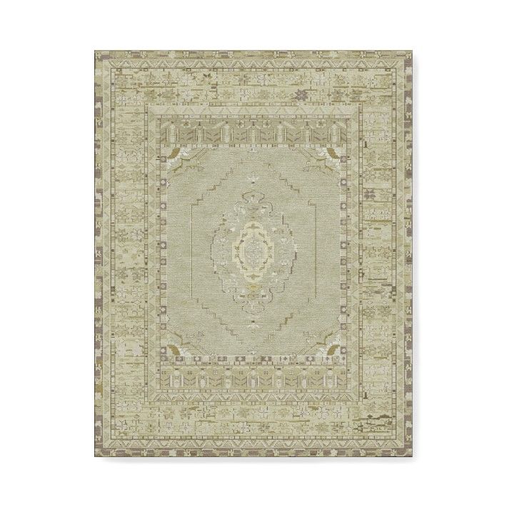 a beige rug with an intricate design on the center and bottom, in front of a white background