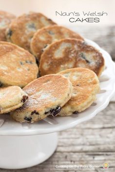 blueberry pancakes on a white plate with the words, nourish cakes above them